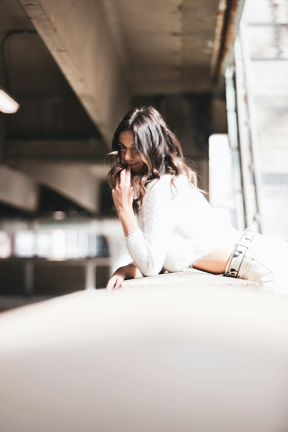 woman in white long sleeve shirt and white skirt sitting on white chair