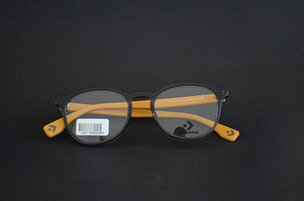 black framed eyeglasses on black textile