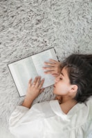 woman in white dress shirt holding white ipad