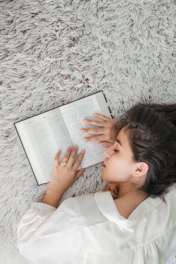 woman in white dress shirt holding white ipad