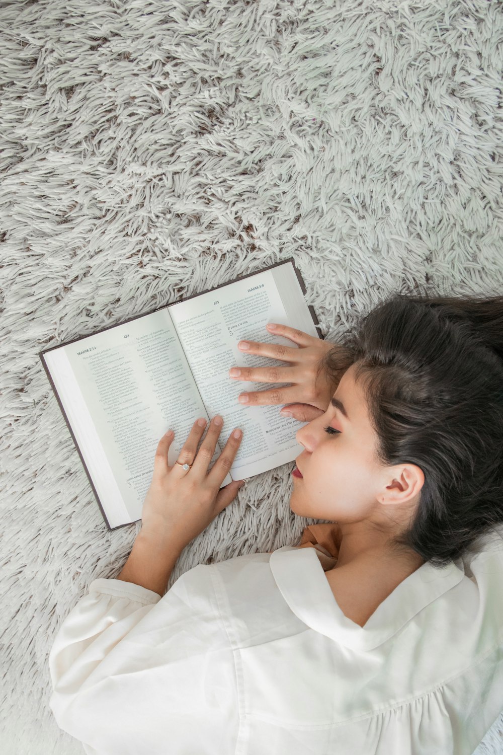 woman in white dress shirt holding white ipad