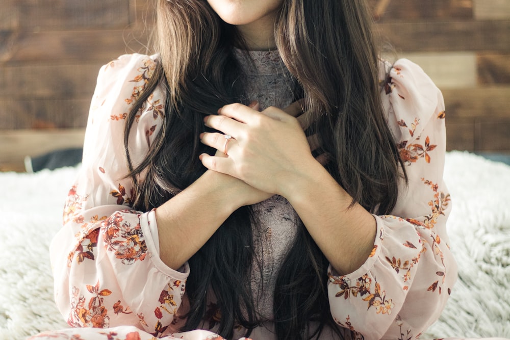 woman in white and red floral long sleeve shirt