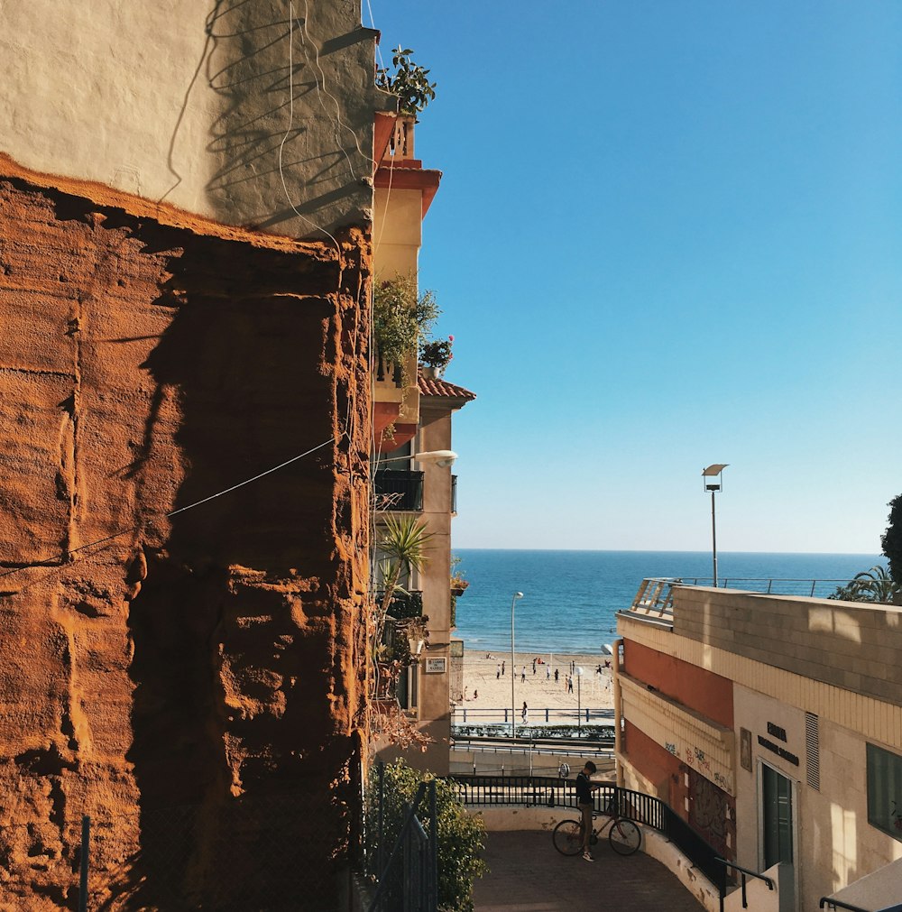 brown concrete building near body of water during daytime