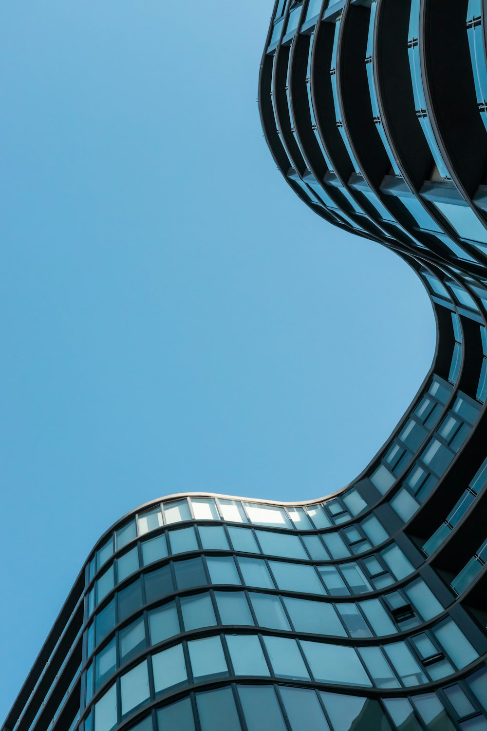 blue glass building under blue sky during daytime