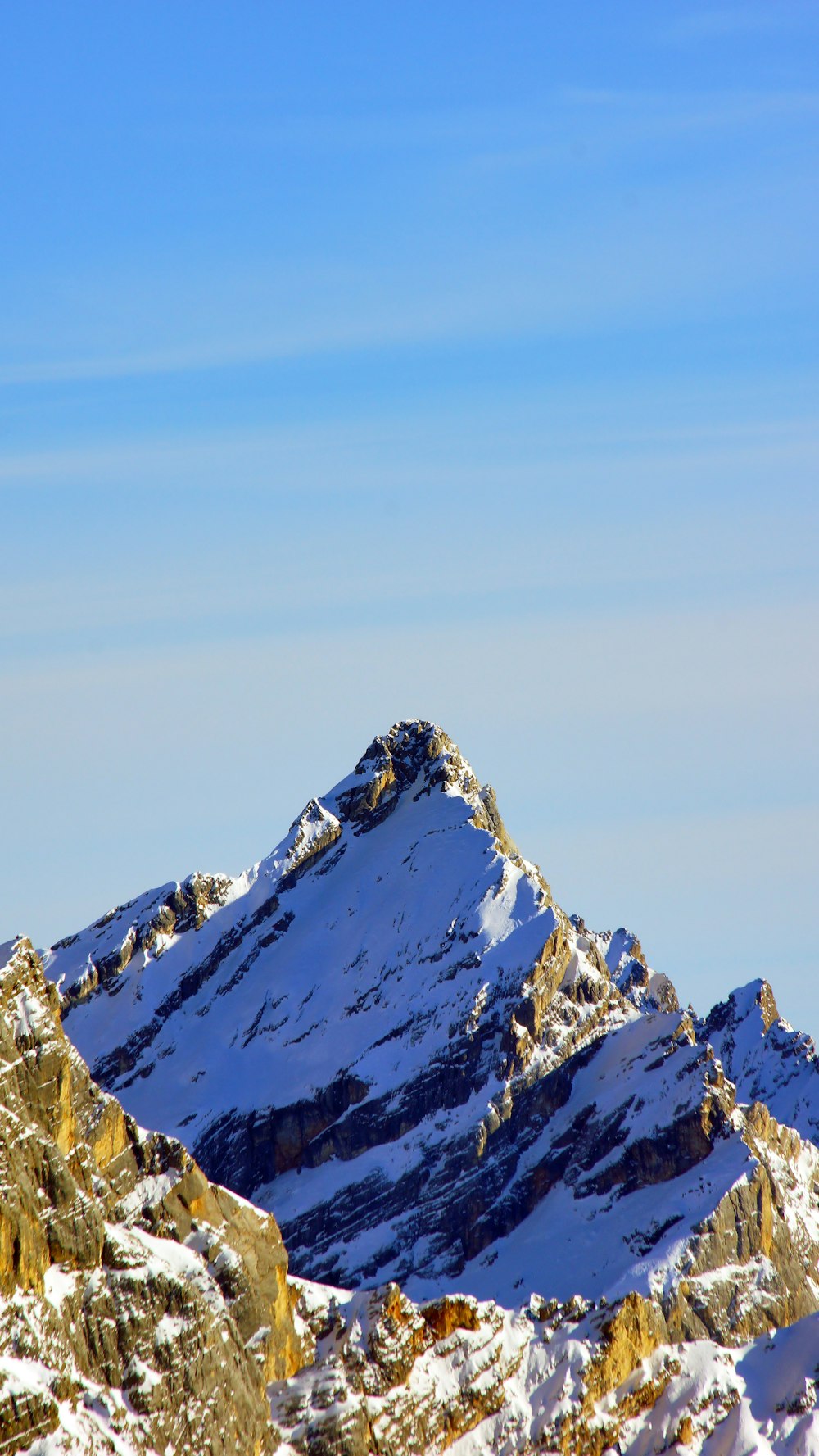 snow covered mountain under blue sky during daytime