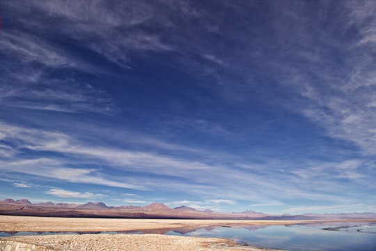 brown sand under blue sky during daytime in Salar de Atacama Chile