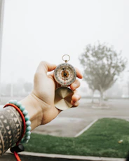 person holding silver round coin
