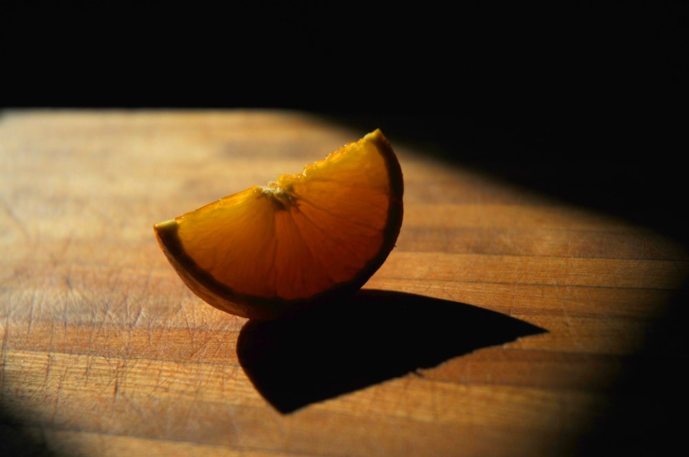 sliced orange fruit on brown wooden table