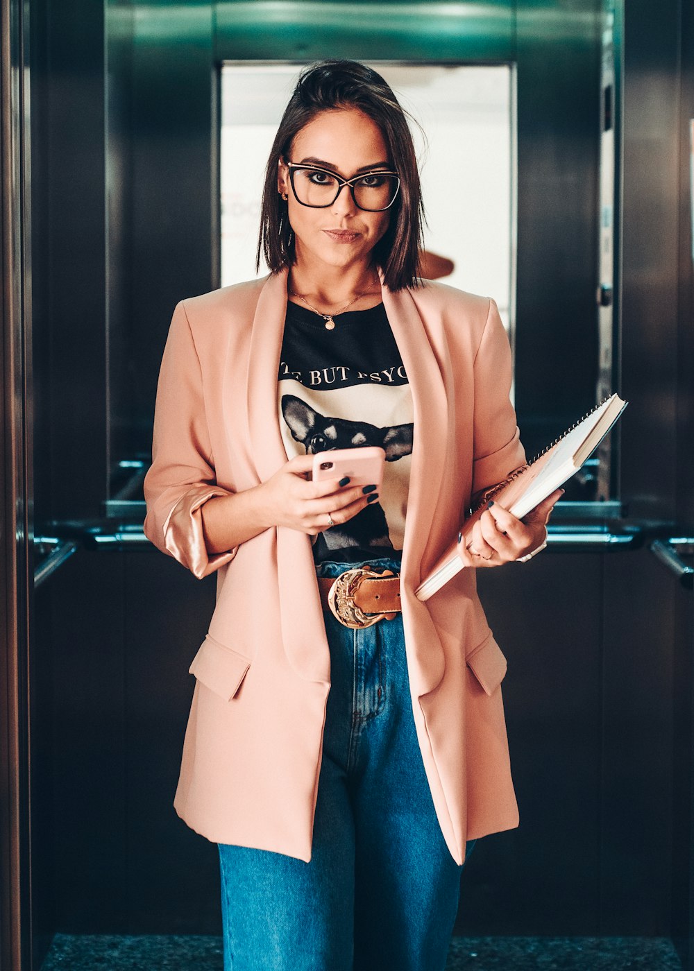 woman in brown blazer holding book