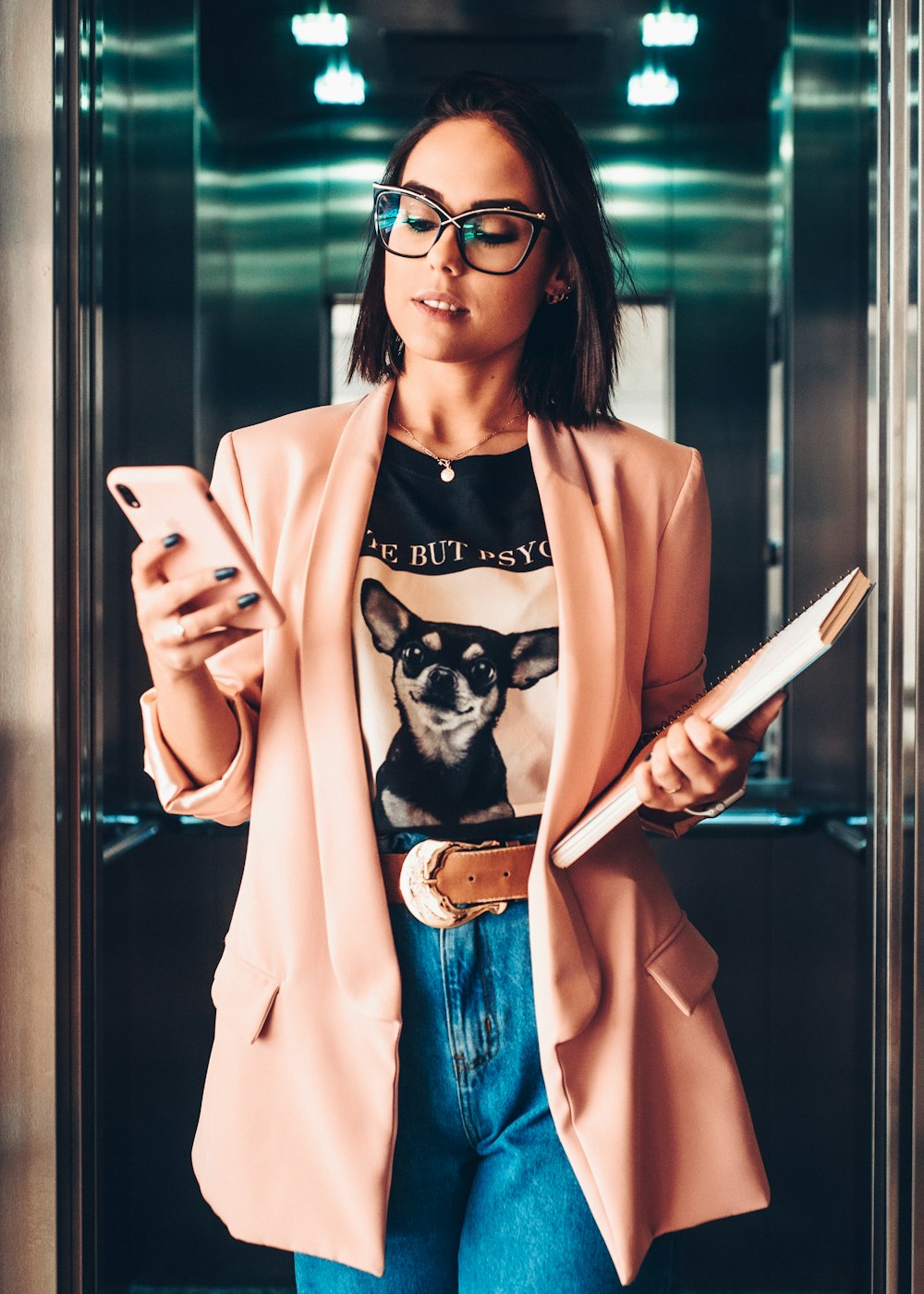 woman in blue denim jacket holding white tablet computer