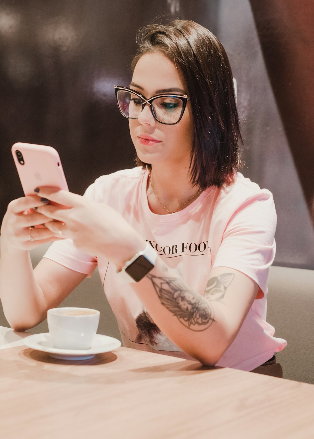woman in white long sleeve shirt holding silver iphone 6