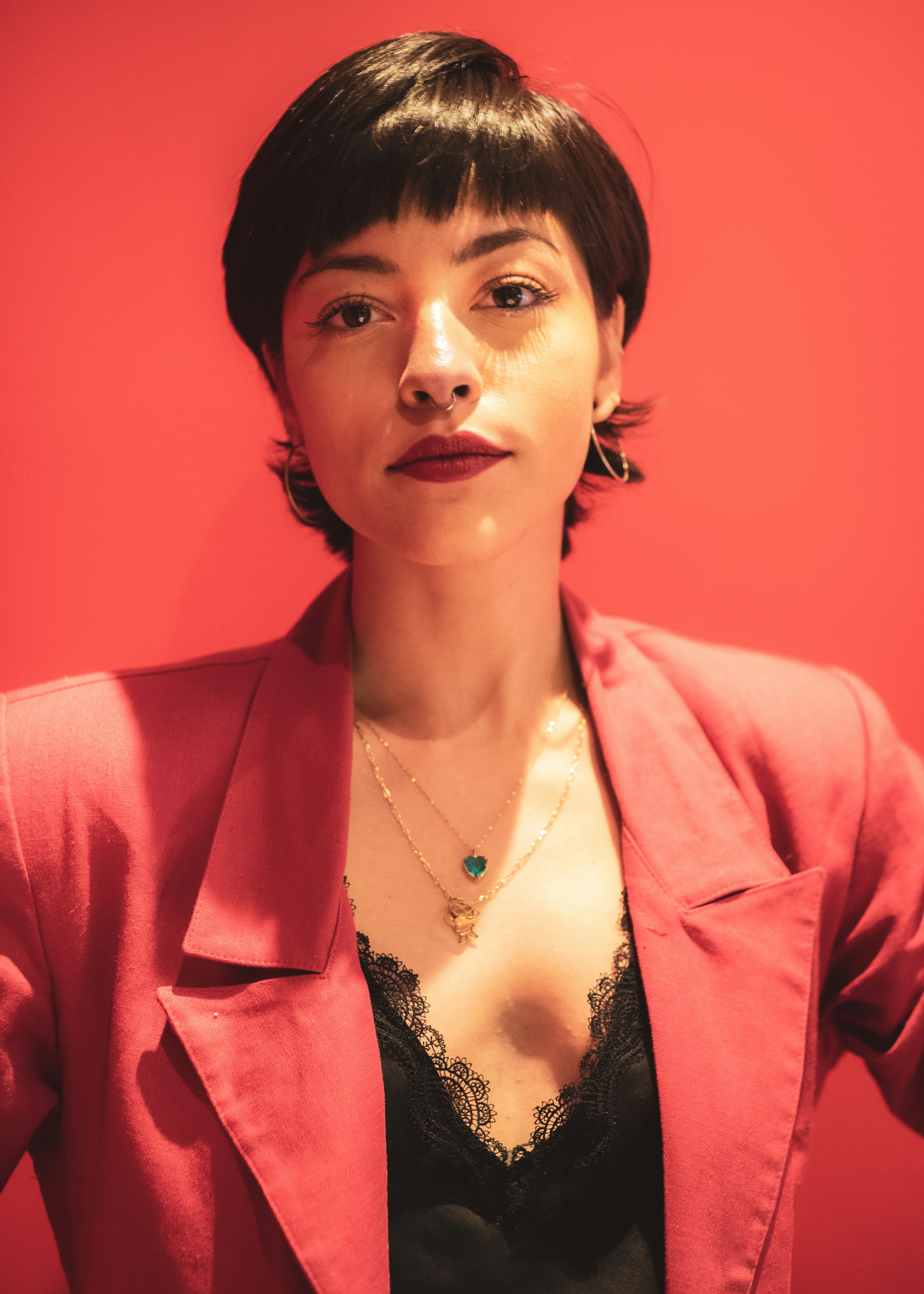 woman in red blazer and silver necklace