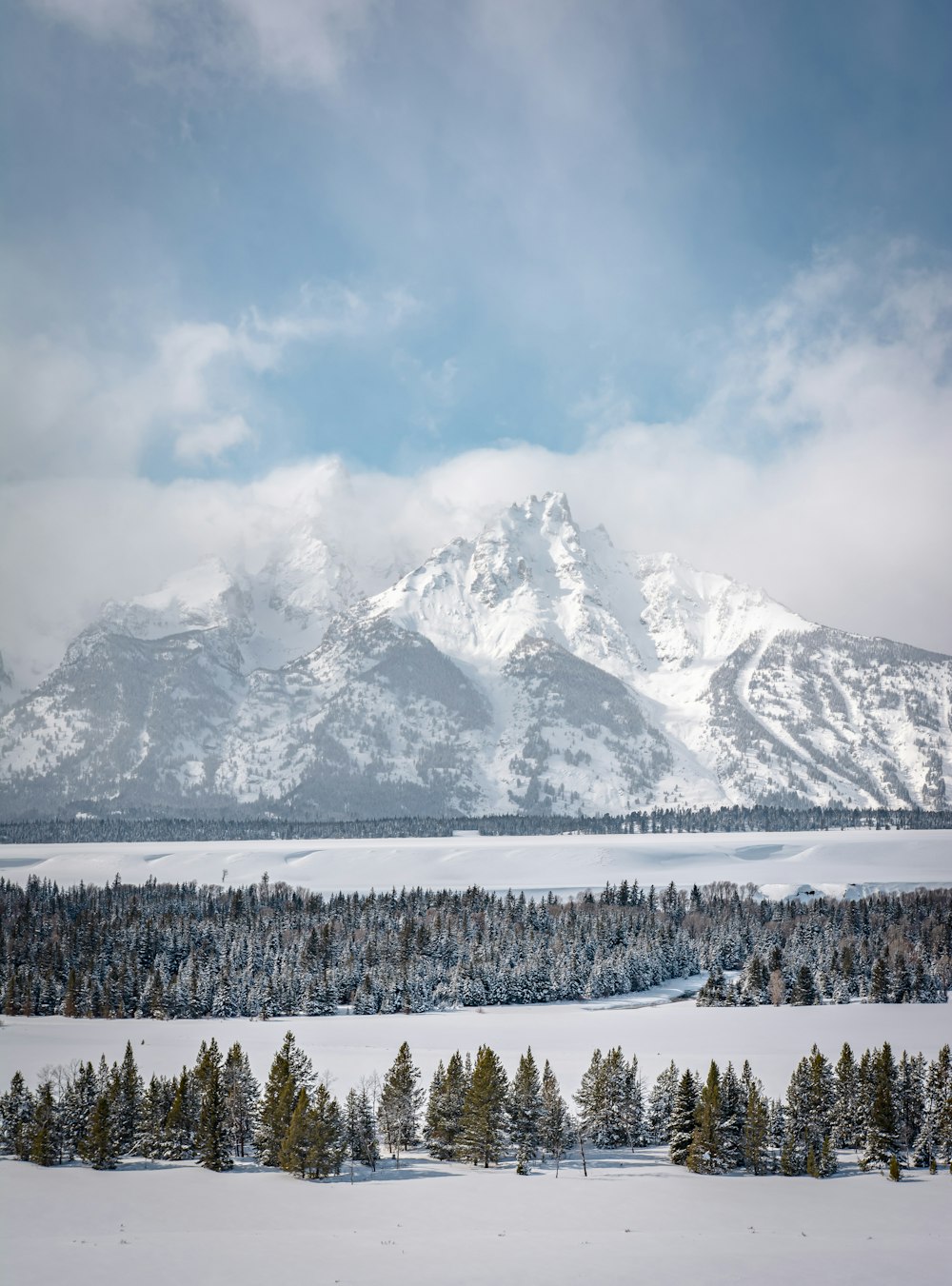 snow covered mountain under cloudy sky during daytime