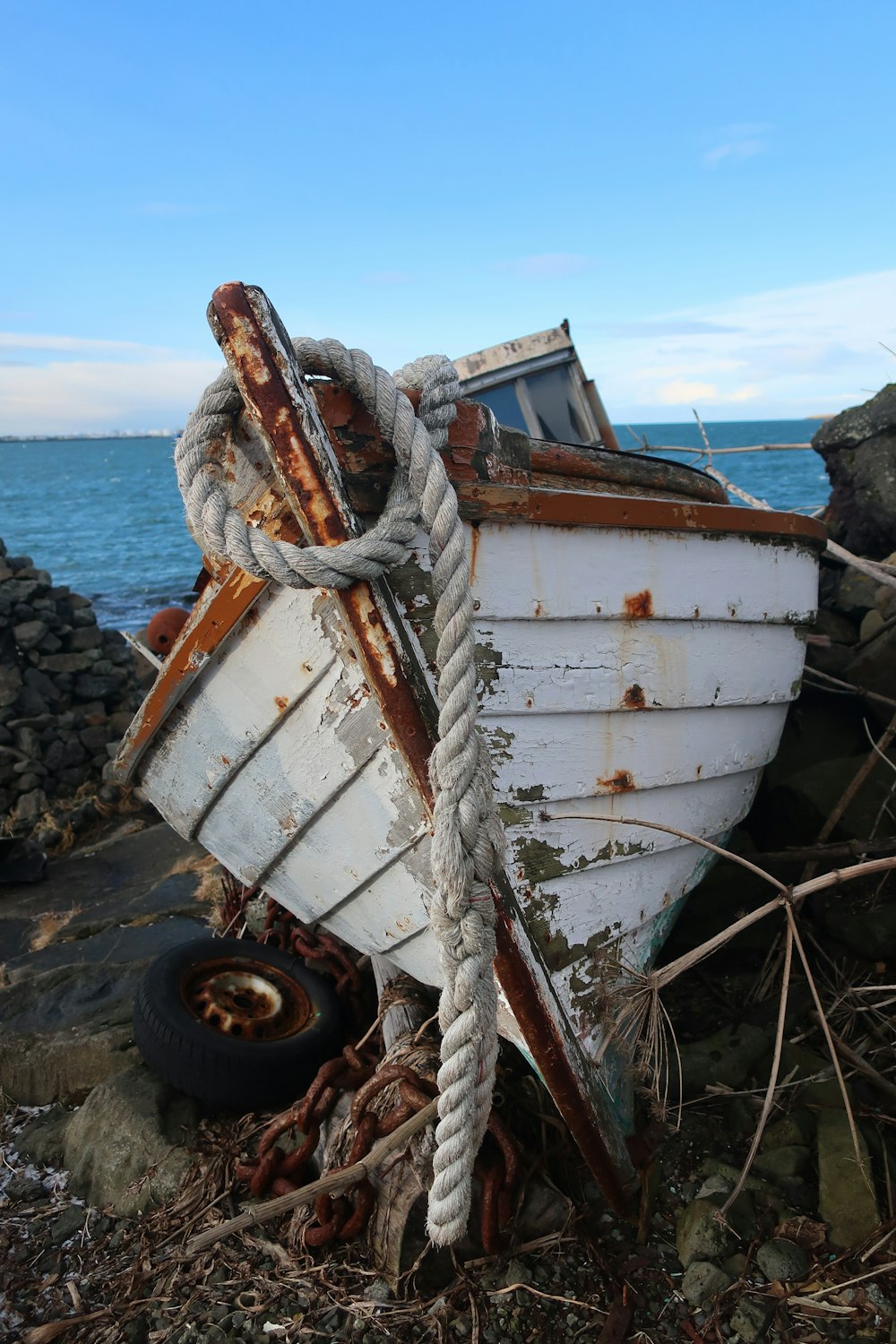 white and brown boat on shore during daytime