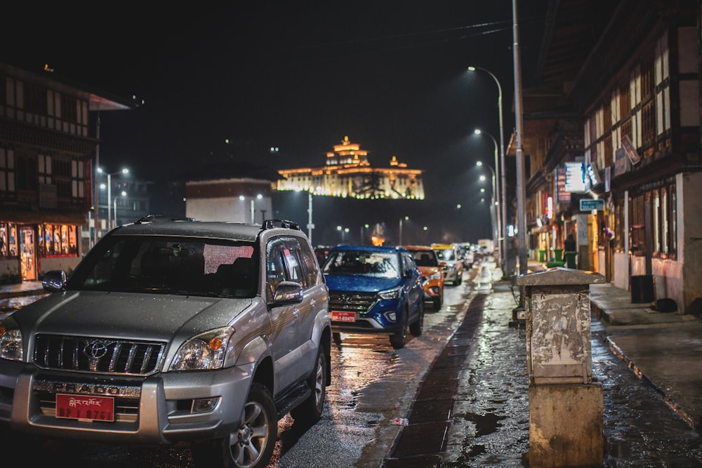 cars parked on the side of the road during night time