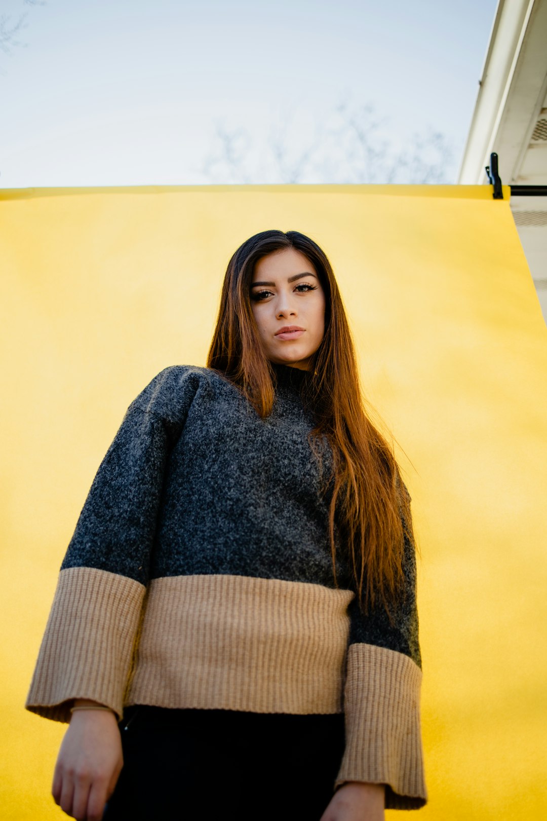 woman in gray sweater standing