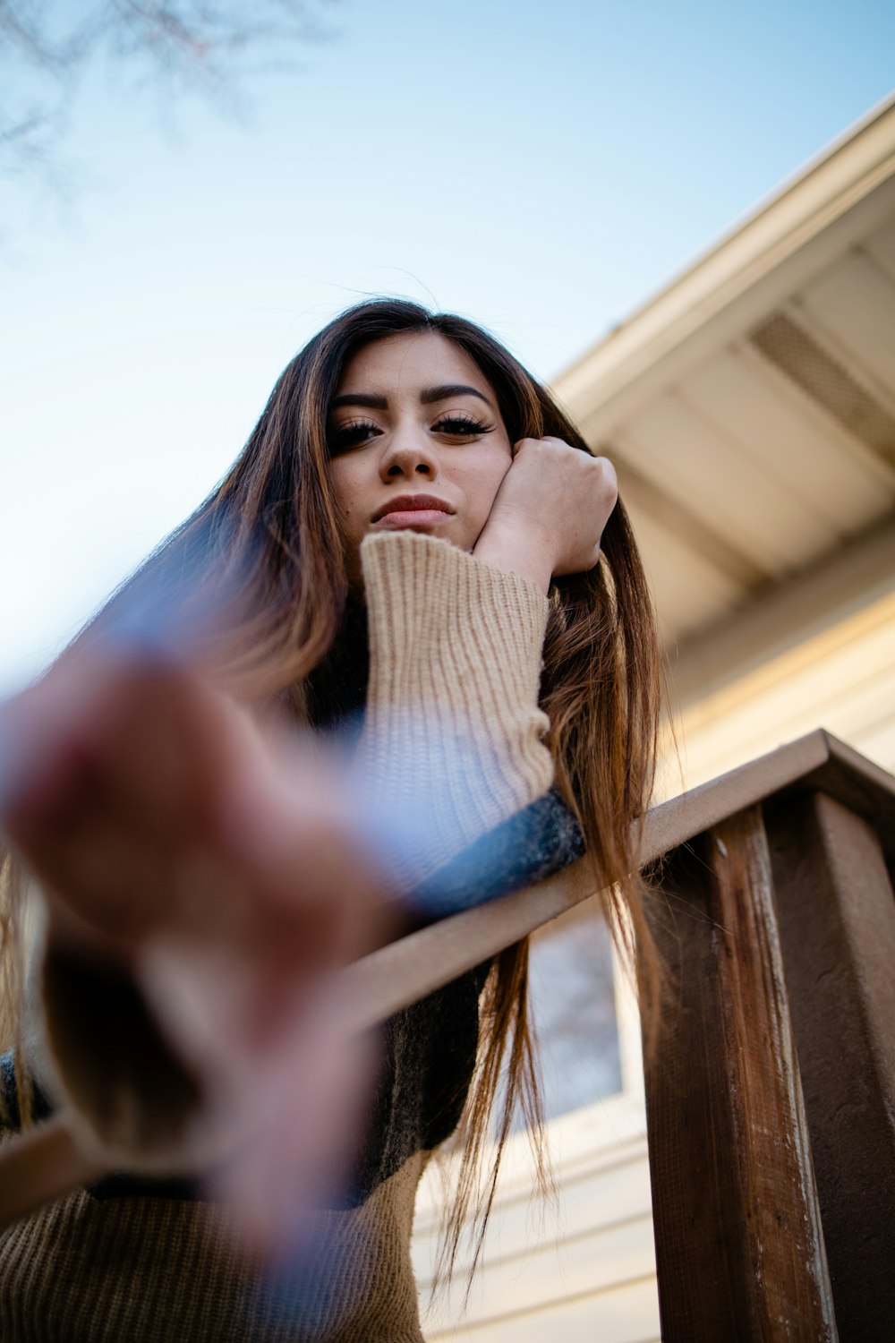 woman in black jacket holding her hair