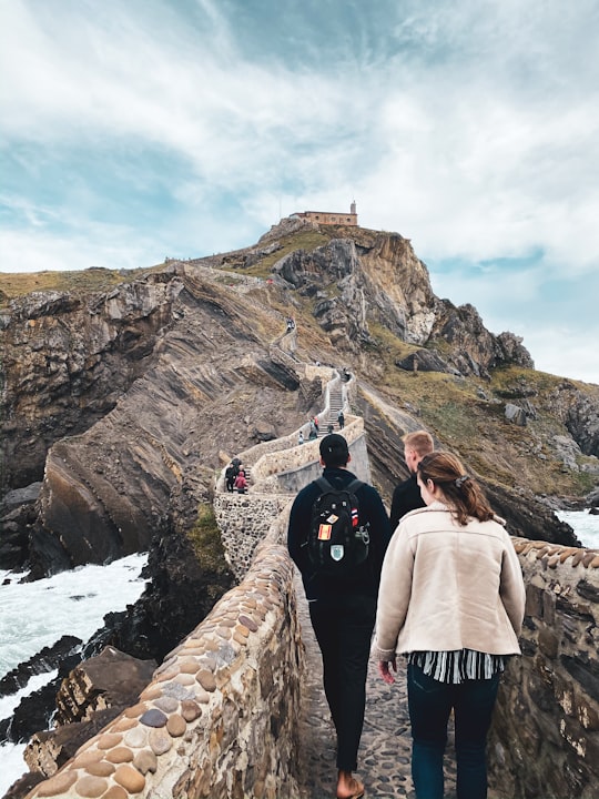 man in black jacket standing on rocky mountain during daytime in País Vasco Spain
