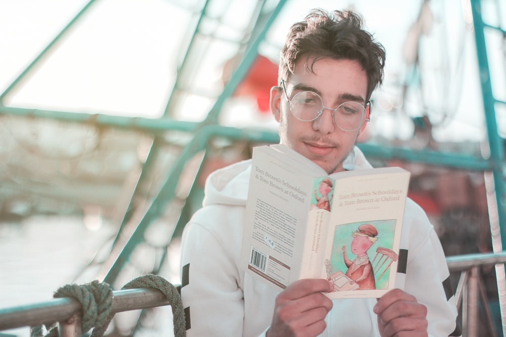 man in white dress shirt holding pink card