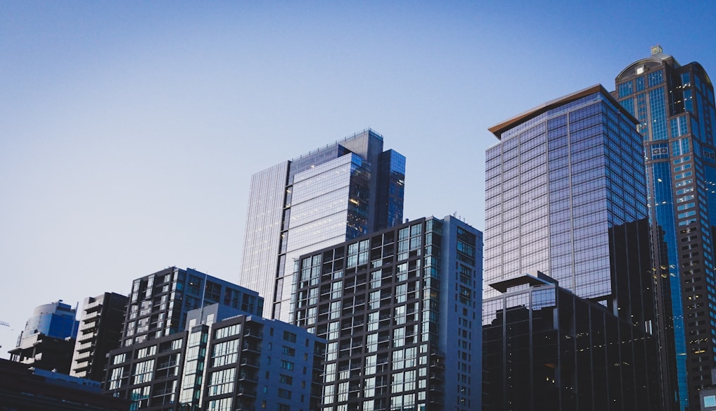 white and blue glass walled high rise building