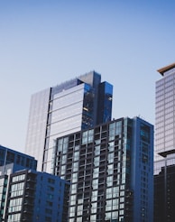 white and blue glass walled high rise building