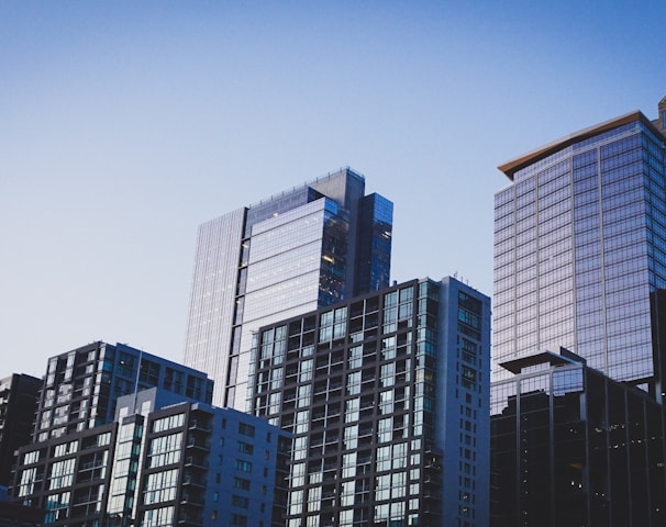 white and blue glass walled high rise building