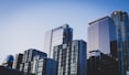 white and blue glass walled high rise building