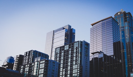 white and blue glass walled high rise building