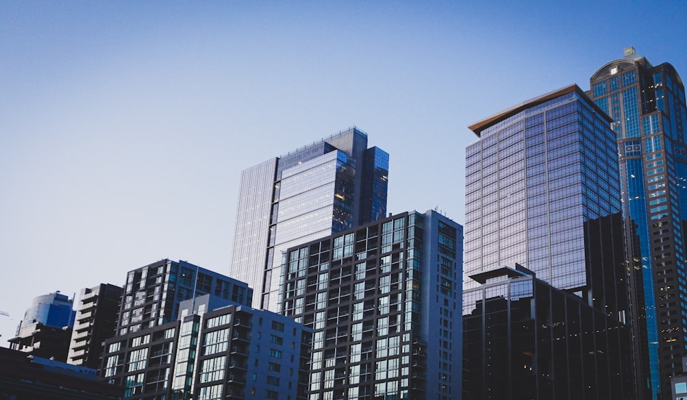 white and blue glass walled high rise building