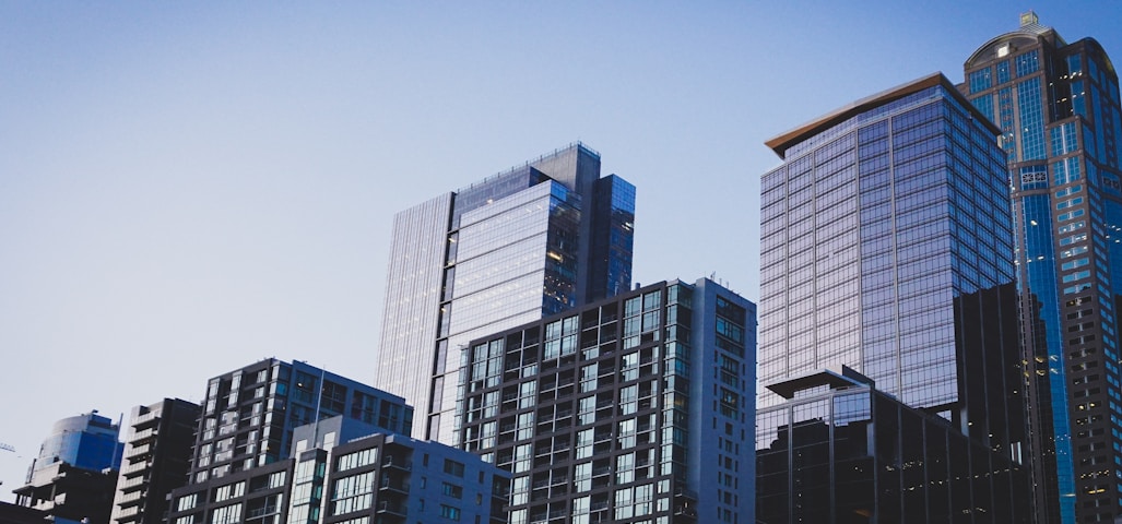 white and blue glass walled high rise building