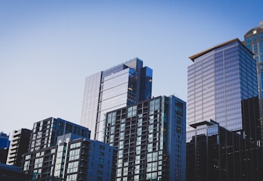 white and blue glass walled high rise building