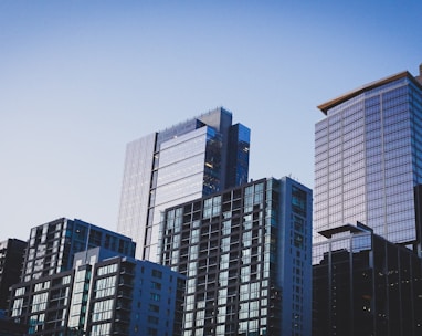 white and blue glass walled high rise building