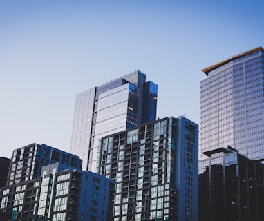 white and blue glass walled high rise building