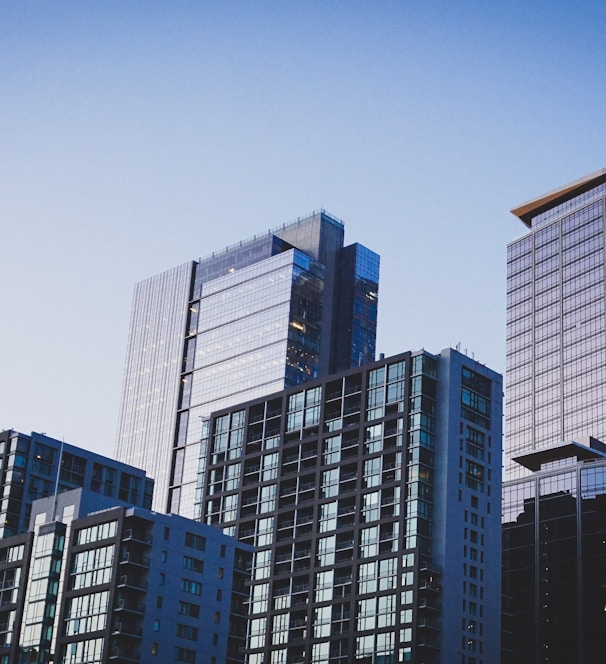 white and blue glass walled high rise building