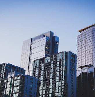 white and blue glass walled high rise building