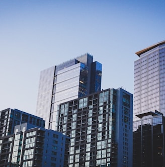 white and blue glass walled high rise building