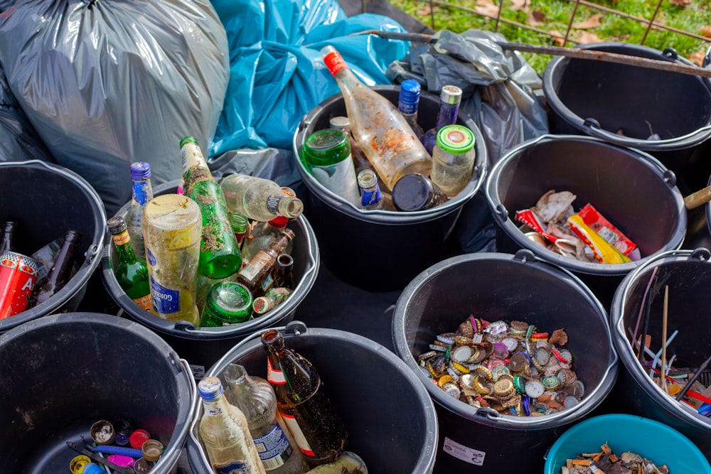 assorted plastic bottles in black plastic bucket