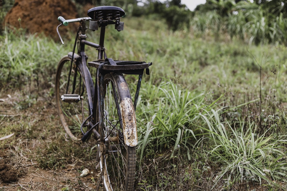 black bicycle on brown soil