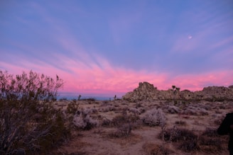 A vibrant desert scene in northern Chile with red rocks and a bright sunset.