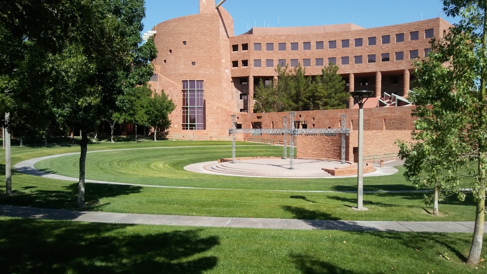 brown concrete building near green grass field during daytime