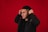 man in black jacket covering his face