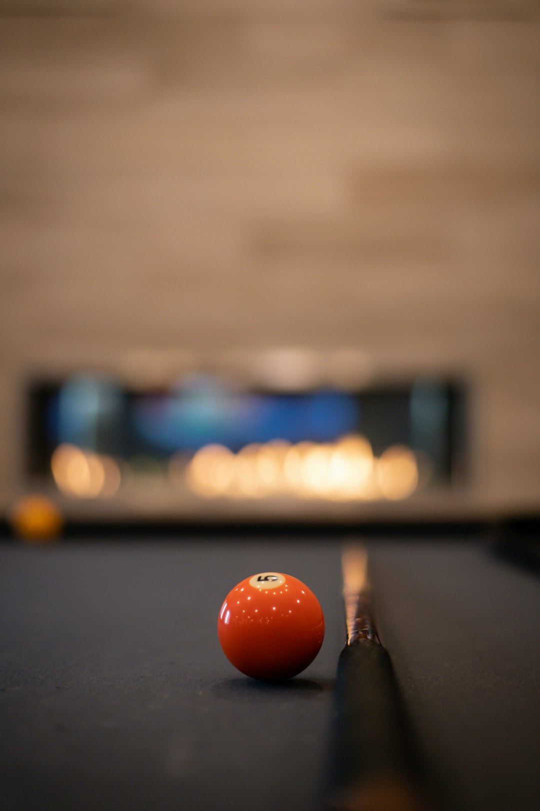 orange billiard ball on billiard table