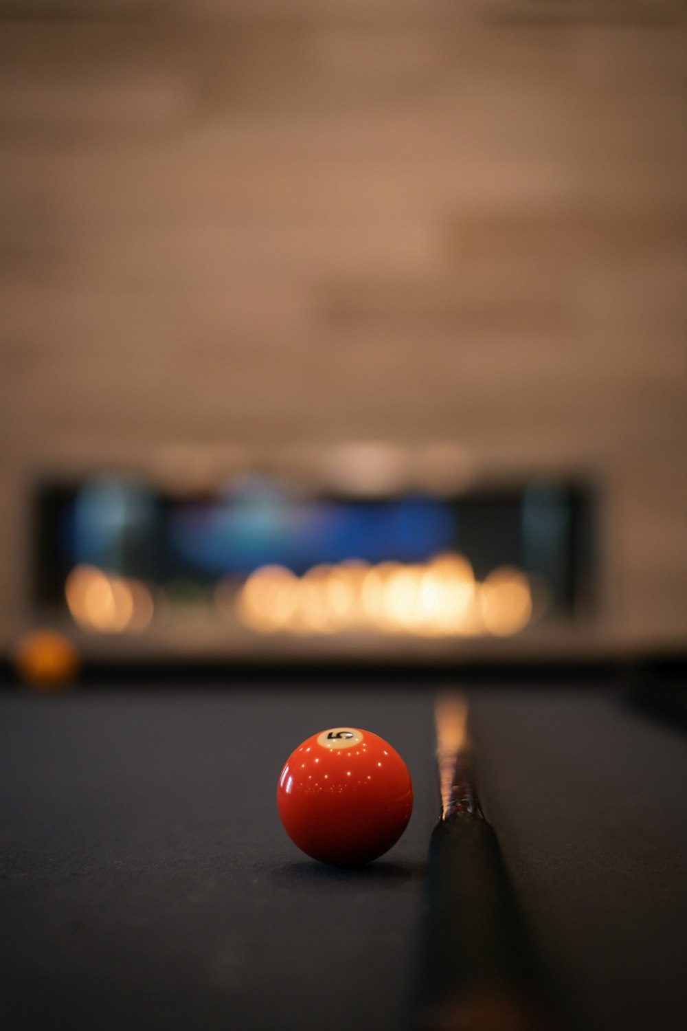 orange billiard ball on billiard table