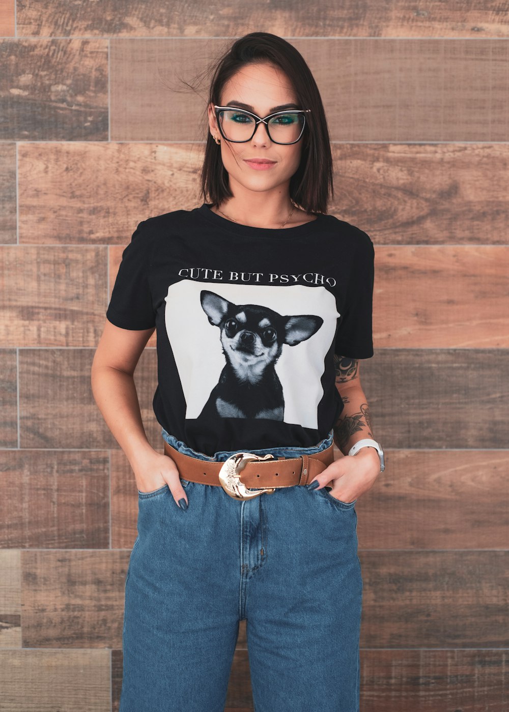 woman in black and white crew neck t-shirt and blue denim jeans wearing black sunglasses