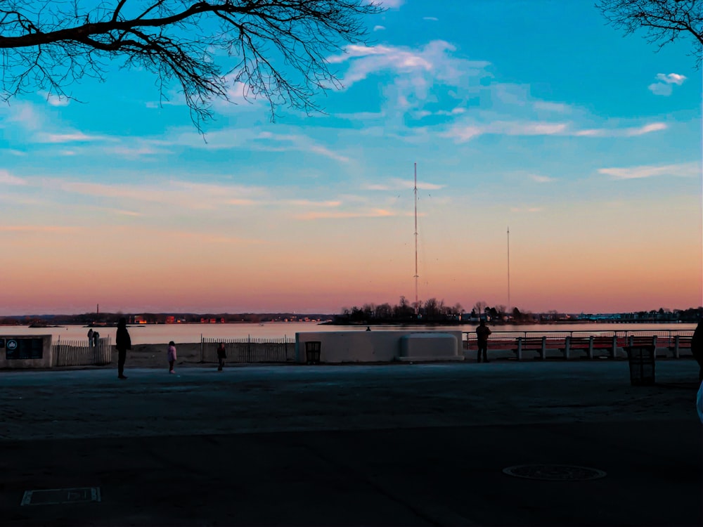 people walking on the street during sunset