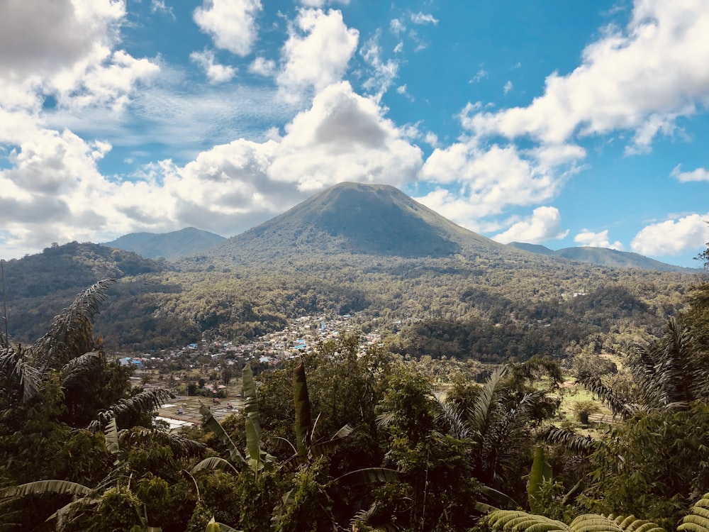 green and brown mountain under blue sky and white clouds during daytime