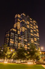 Night view of the building exterior glowing softly under street lights, showcasing a safe environment.