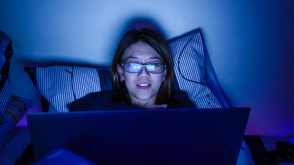 A student studying late at night using Neecet’s portal on a laptop under soft blue lighting.