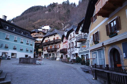 Charming historic village street with cobblestone paths and colorful houses.