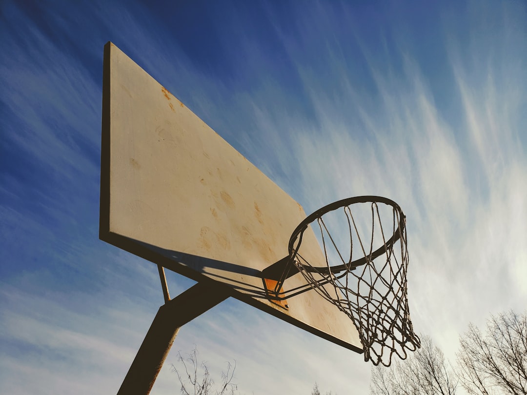white basketball hoop under blue sky during daytime